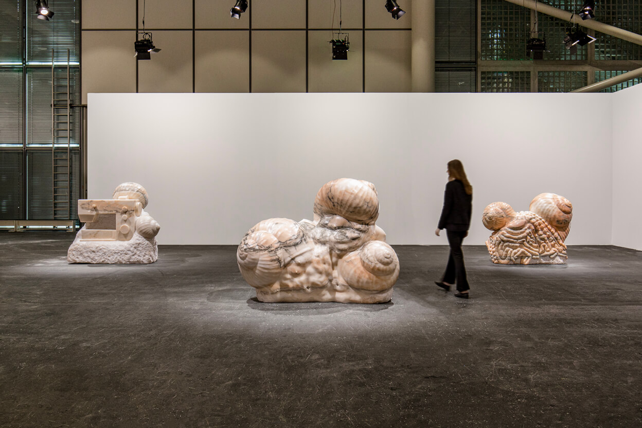Daniel Dewar & Grégory Gicquel, Stone triptych with snails, body fragments and sewing machine, 2025. Installation view at Art Basel Unlimited, 2025. ©  Photos Gabriele Abbruzzese.